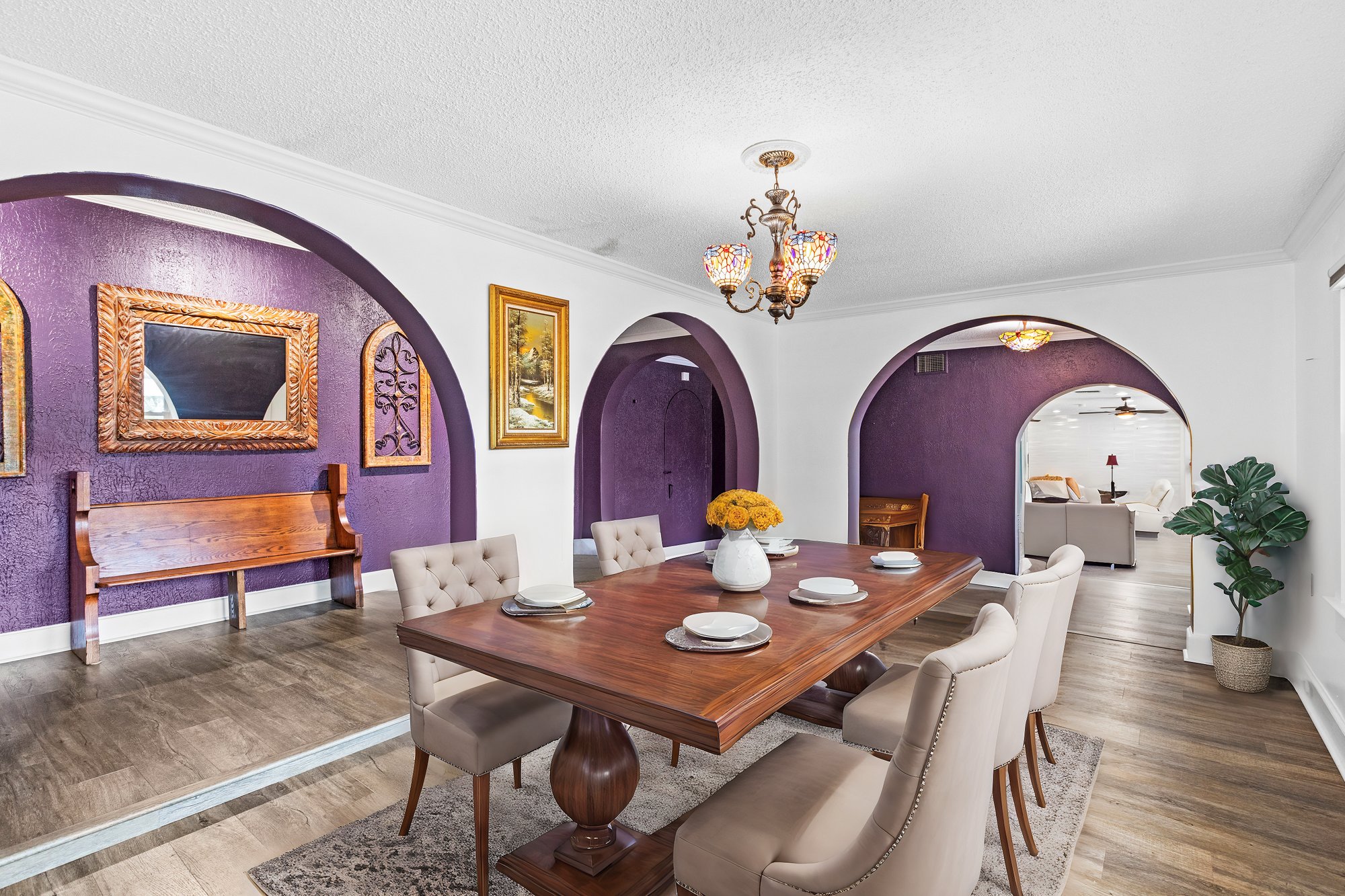 room with table and chairs and arched doorways